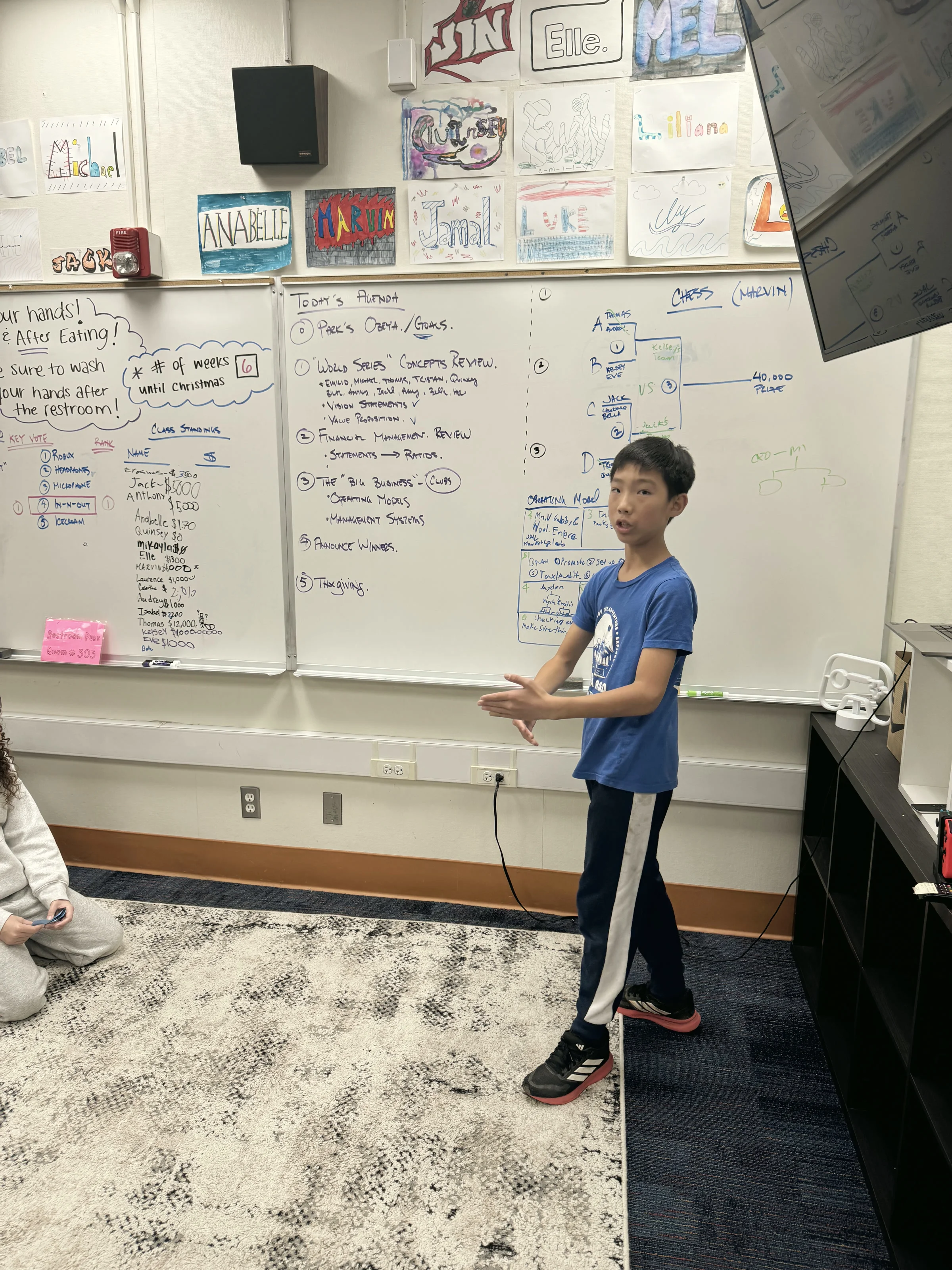 Student presenting at whiteboard